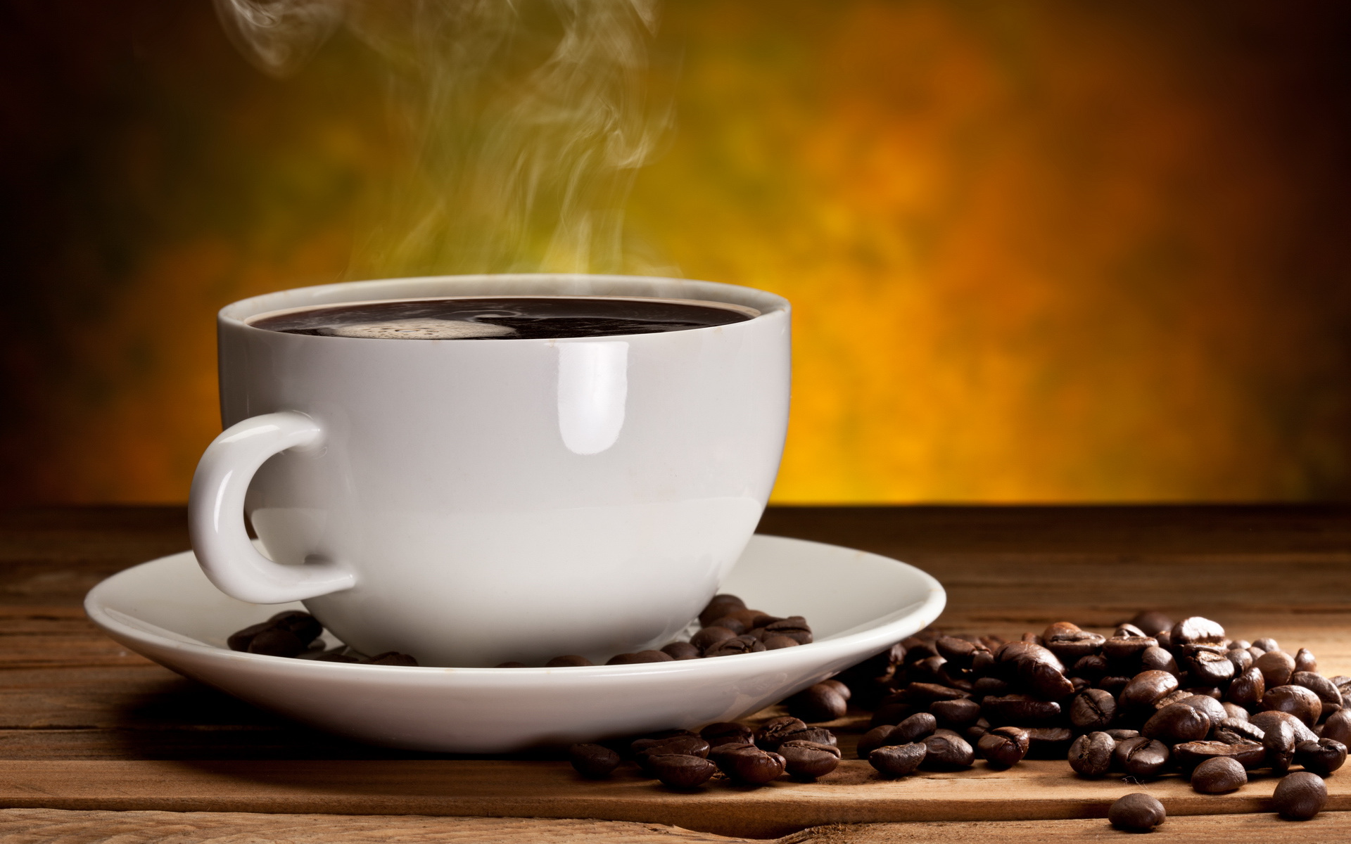 Cup of coffee with coffee beans on a beautiful brown background.