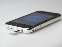 File-Top_and_left_side_of_iPhone_3G_white_showing_the_standby_button,_sim_tray,_headphone_plug,_silent_switch_and_volume_buttons_showing_the_sim_tray_half_pulled_out
